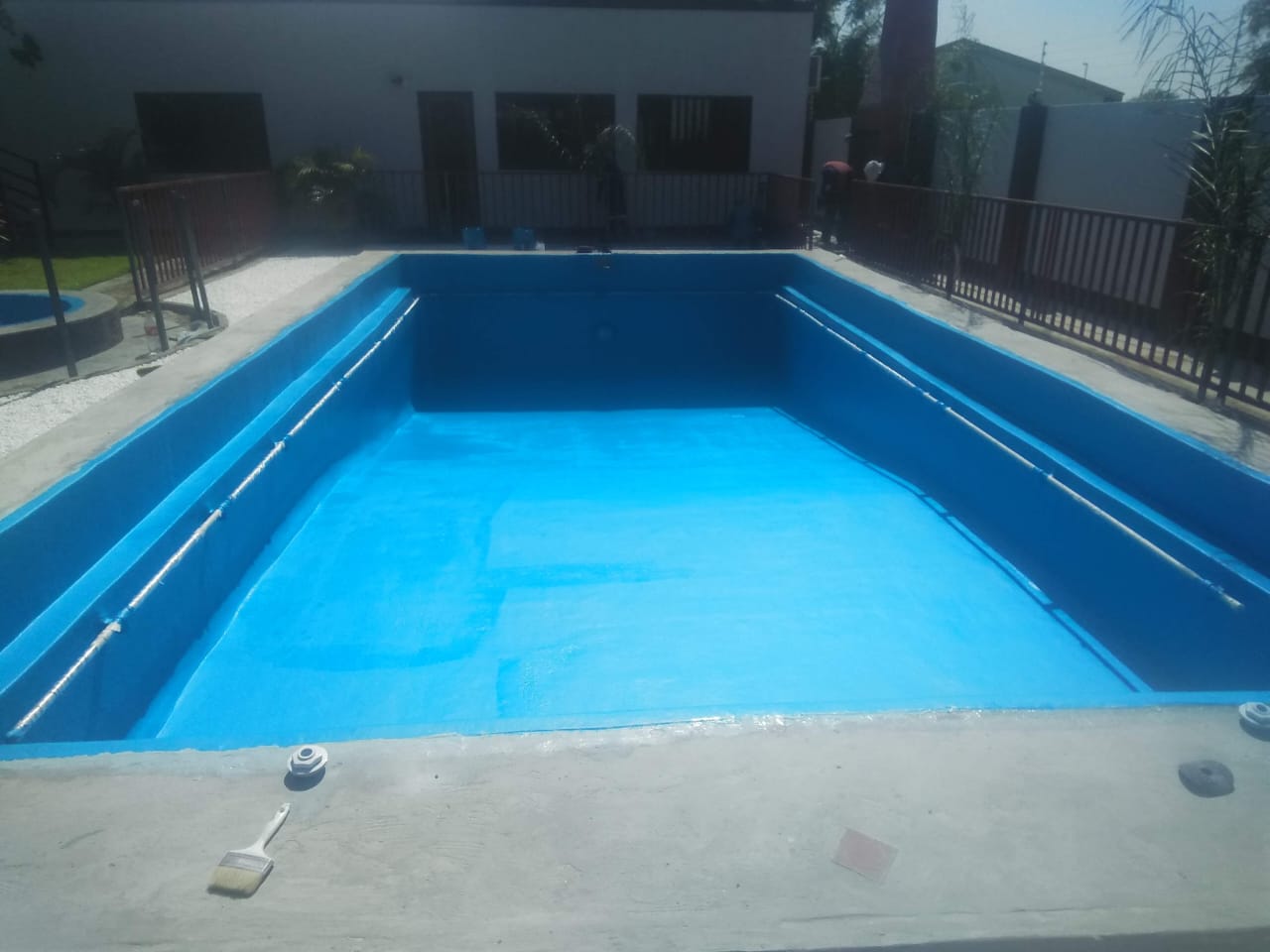 Empty pool freshly relined in bright blue marbelite