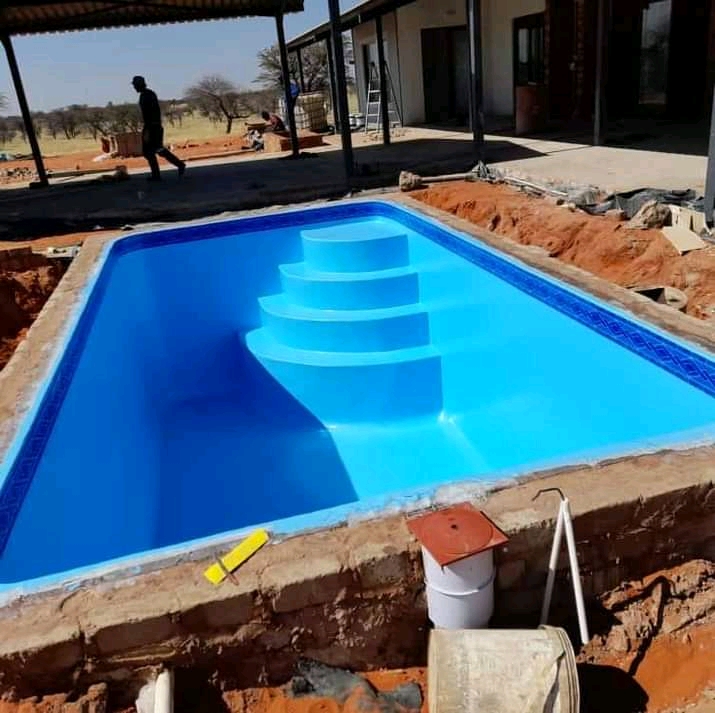 Newly installed fibreglass pool shell with moulded steps